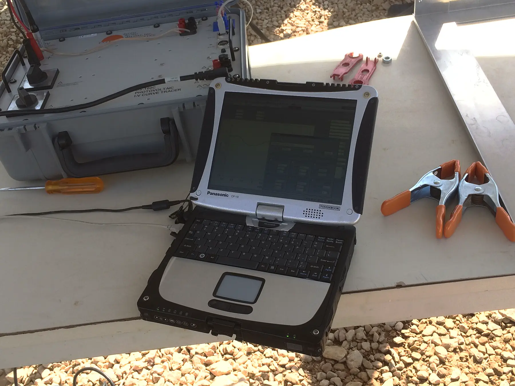 Rugged convertible laptop open on a workbench outdoors