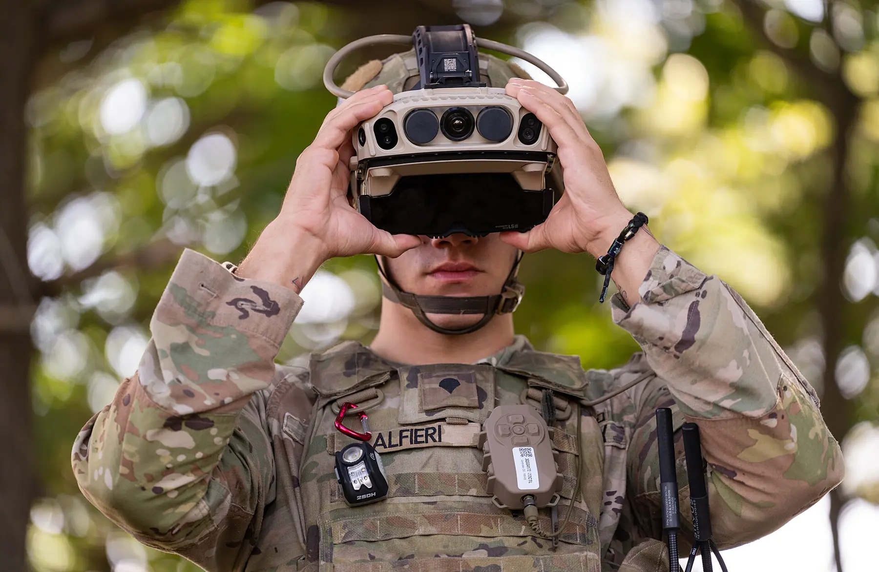 Soldier fitting a prototype mixed-reality headset with front-mounted sensors