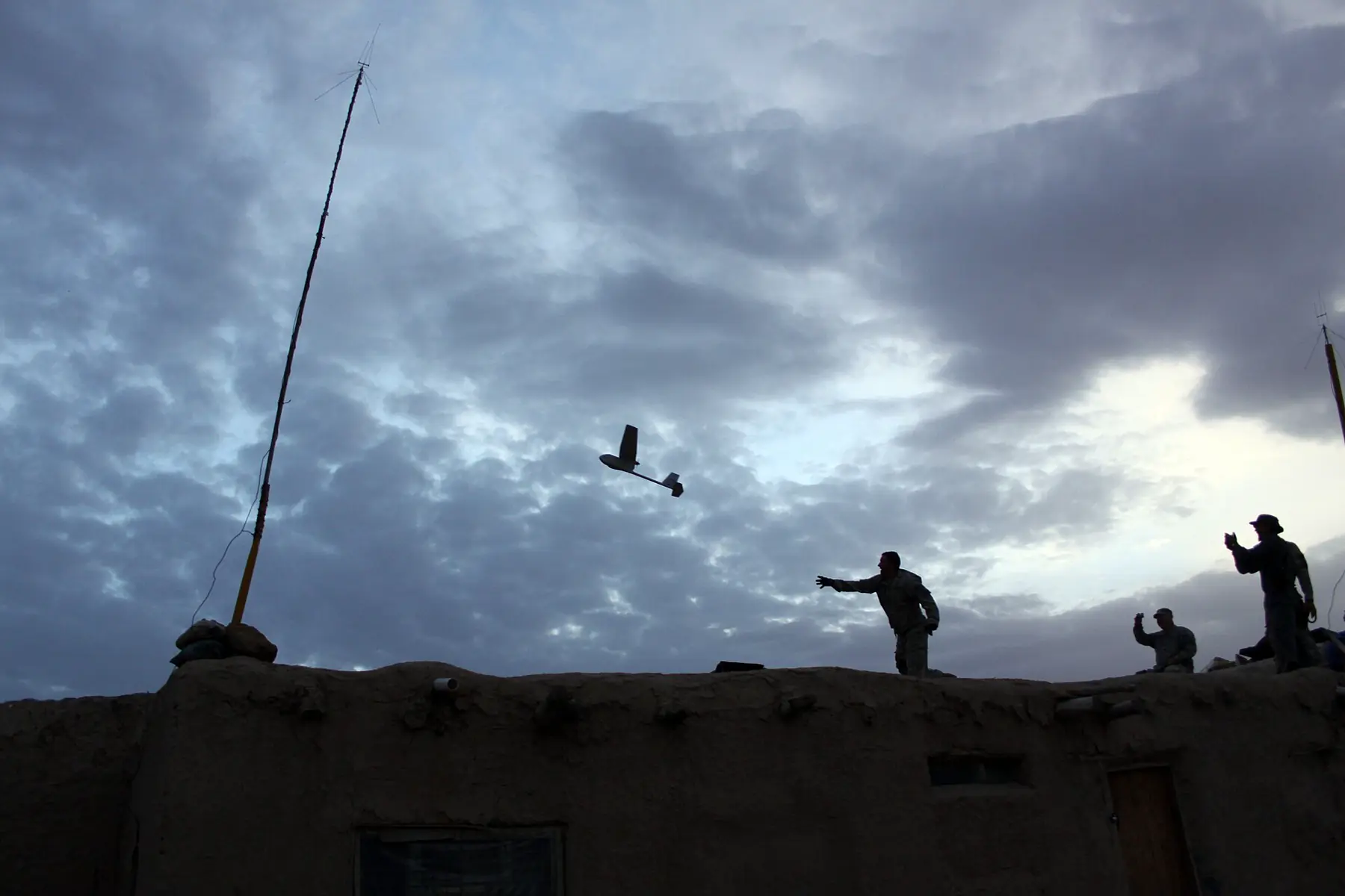 Small unmanned aircraft in flight moments after a hand launch at twilight